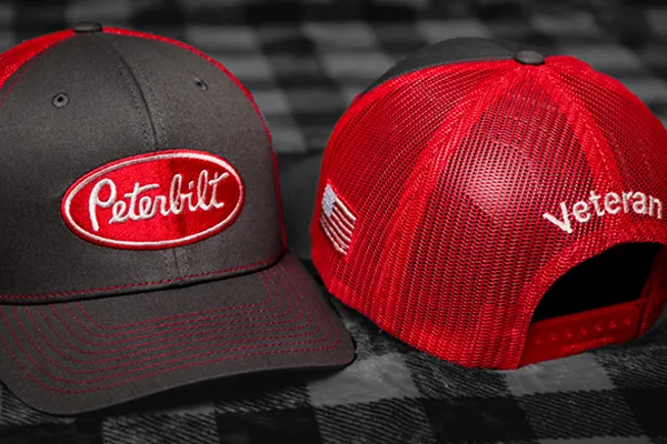 Image of two special Peterbilt Veteran employee hats